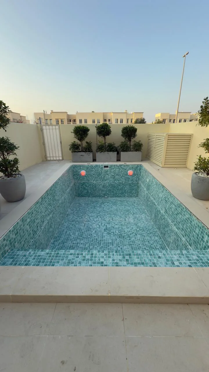 Finished pool tiled in green mosaic at an Abu Dhabi townhouse