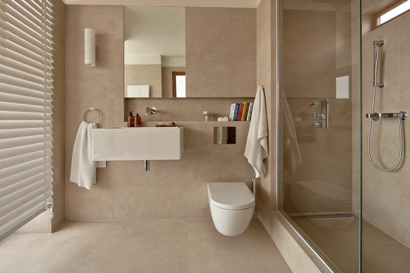 Completed villa bathroom with large format tiles and chrome fittings